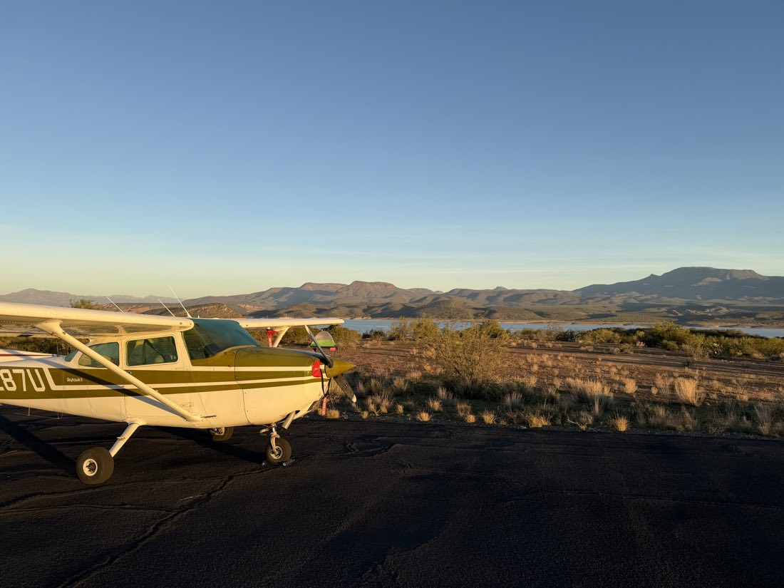 N1287U parked at a remote Arizona airstrip with a tent beside it